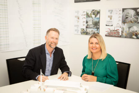 VPC Acting Chair Stuart Kollmorgen and Lifeview CEO Madeline Gall, sign partnership agreement on the site of the Victorian Pride Centre, due to open late 2020