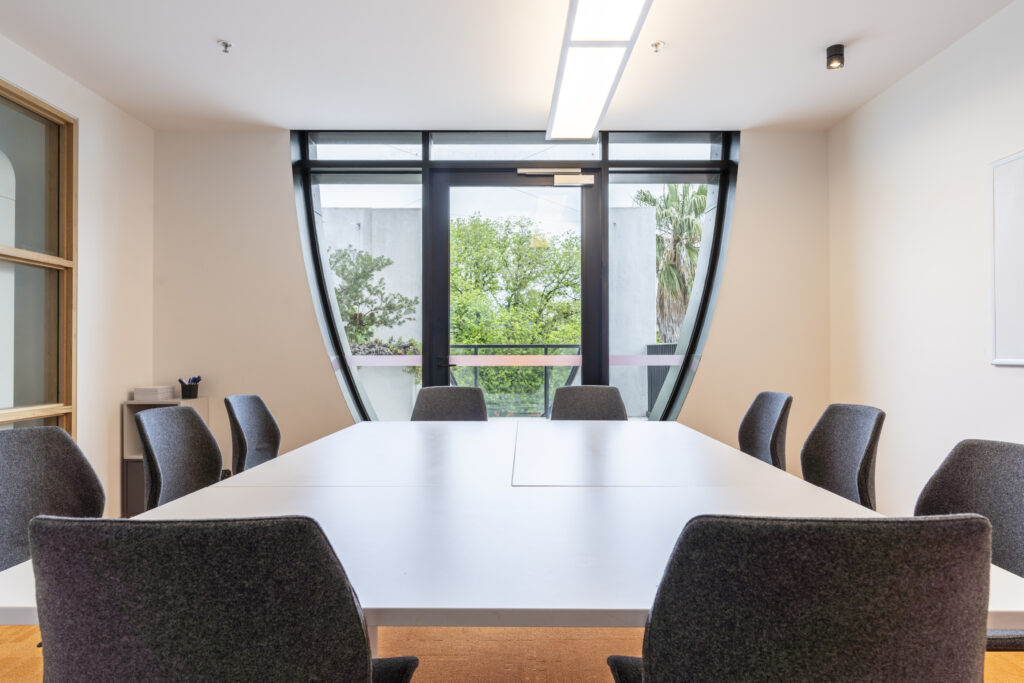 Meeting Room 4 with chairs and tables and a window looking out onto Fitzroy St.