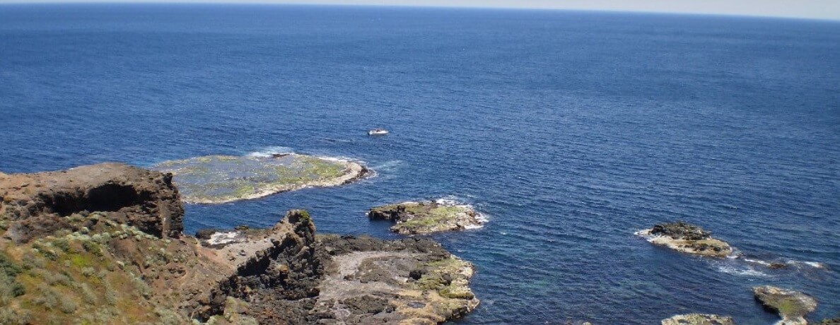 Cliffs and a large body of water that stretches indefinity