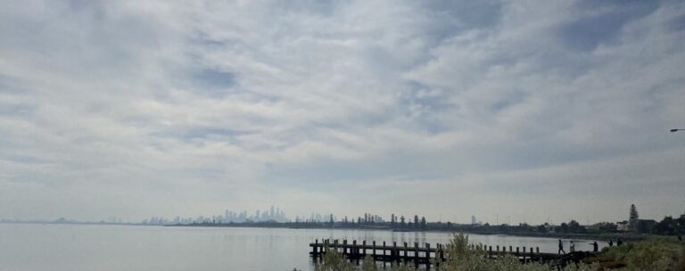 Brighton Port - an open body of water with a hazey city in the background