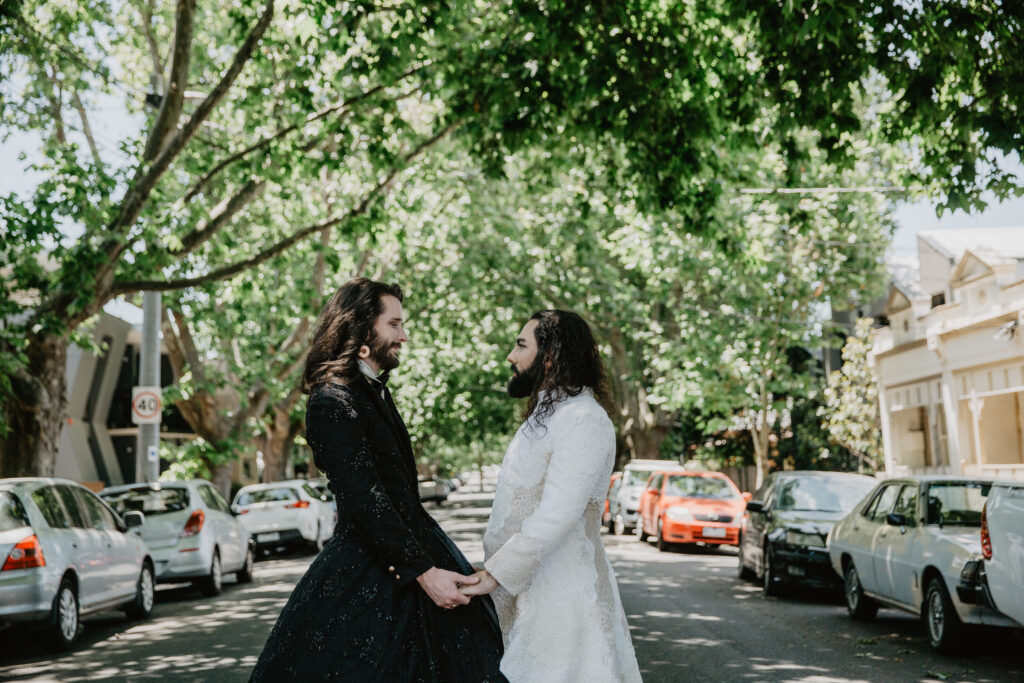 two people standing in the street in a wedding like embrace