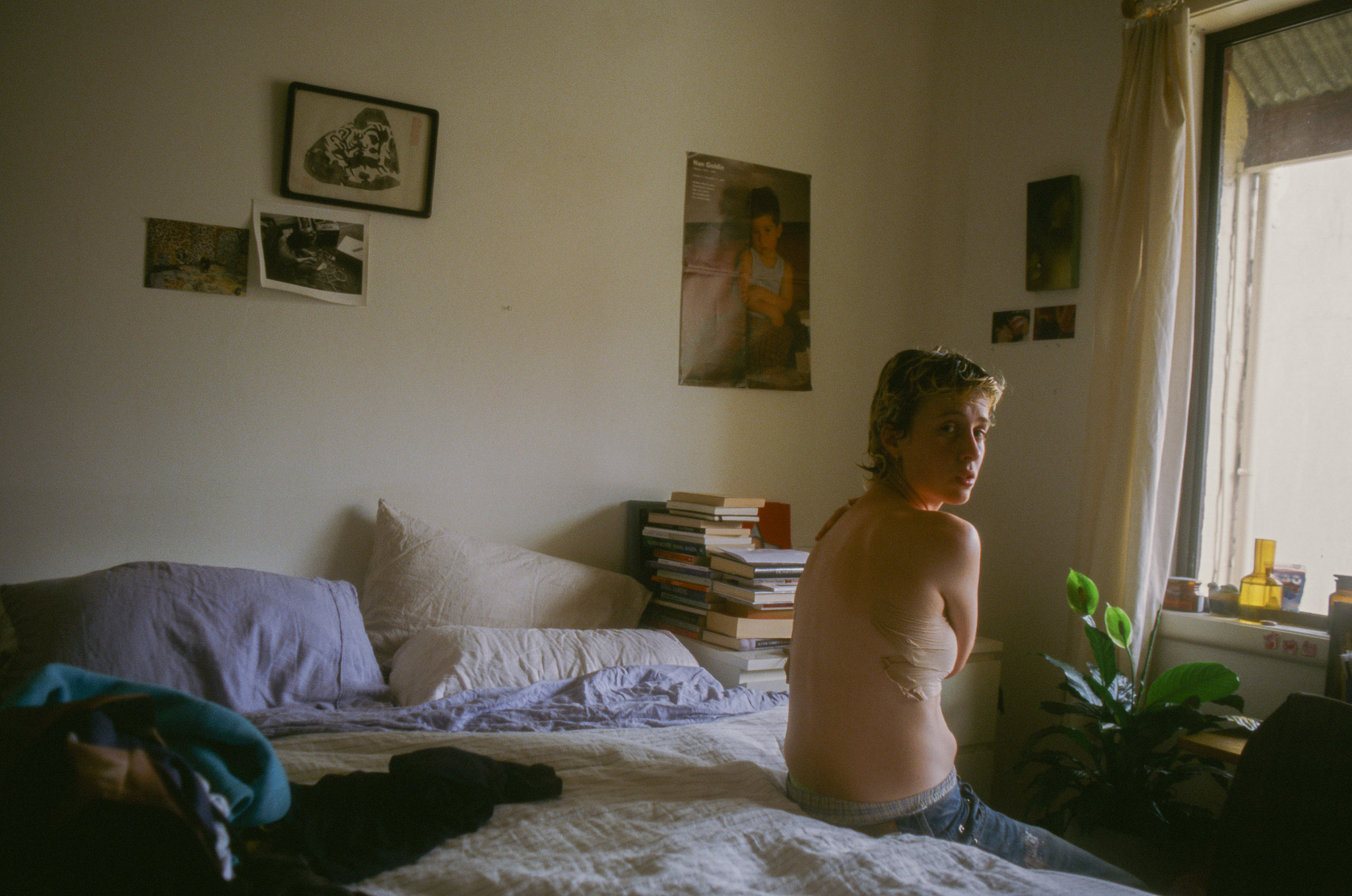 Clemm Jett. A person sits in a bedroom with top strapping.