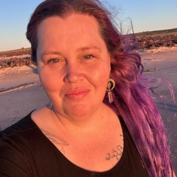 Headshot of Skye Stewart in front of a beach landscape